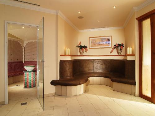 a lobby with a bench and candles on the wall at Hotel Alpenhof Kristall in Mayrhofen