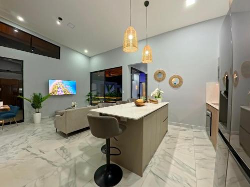 a kitchen with a island and a living room at Villa 7 min to Beach in Quepos