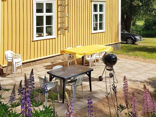 a table and chairs in front of a yellow house at 7 person holiday home in SANDHEM-By Traum in Sandhem
