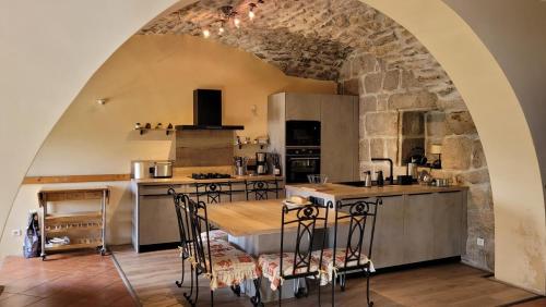 a kitchen with a table and chairs in a room at Gites de france aux badieux in Les Badieux
