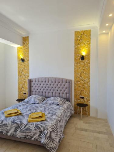 a bedroom with a bed with yellow towels on it at Maison Dar Khalil in Hammamet