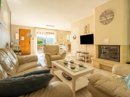 a living room with a couch and a fireplace at Cosy villa in Montouliers with private pool in Montouliers