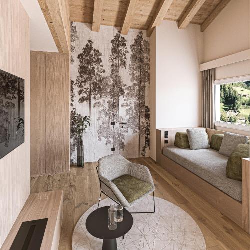 a living room with a couch and a table at Wellness Hotel Dolomia in Soraga