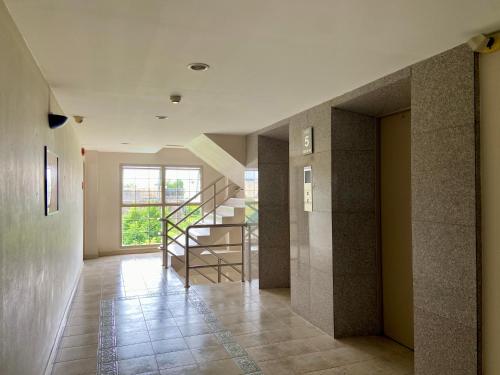 a hallway with a staircase in a building at ศรีย่าน เรสซิเดนซ์ Sriyan Residence in Dusit