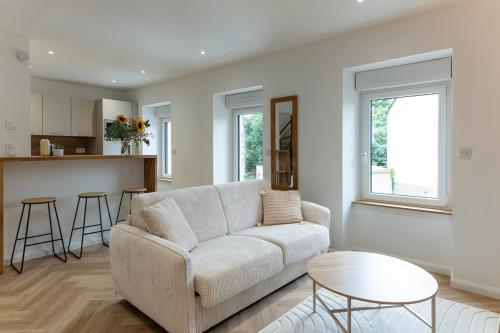a living room with a couch and a table at La Loge du Roi Arthur in Campénéac