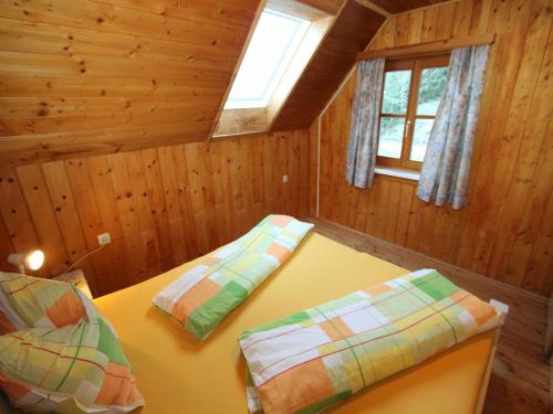 a room with a table and two beds in a cabin at Chalet in Prebl near Klippitztörl Ski Area in Prebl