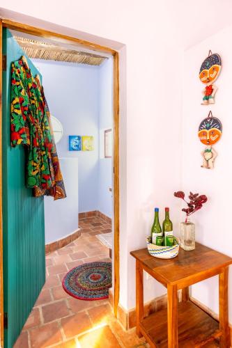 a door leading into a room with a table and wine bottles at Chameleon Hill Forest Lodge in Bwindi