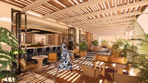 a rendering of a lobby with plants and a woman walking at Kimpton Los Monteros Marbella by IHG in Marbella