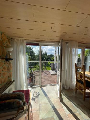 an open living room with sliding glass doors at Haus Simon in Vogelsang