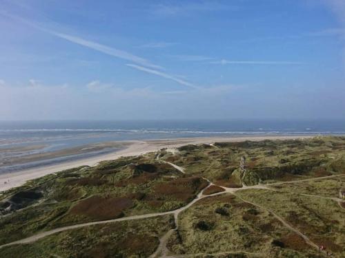 an aerial view of a beach and the ocean at 8 person holiday home in Blåvand in Blåvand