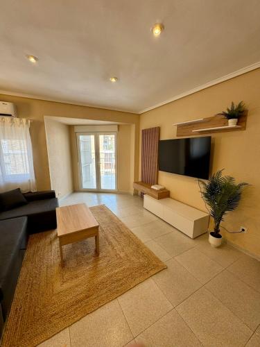 a living room with a couch and a tv at 1st Line Beach Direct Access Private Parking in Valencia