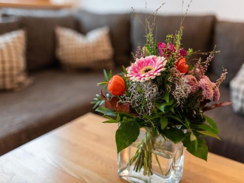 a vase filled with flowers on a table at Ferienwohnung, Bernau in Bernau im Schwarzwald
