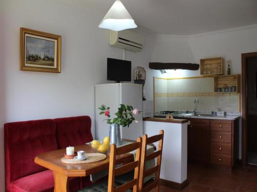 a kitchen with a table and a kitchen with a refrigerator at Cottage in Santa Comba with Pool in Ponte de Lima
