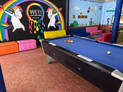 a room with a pool table and a rainbow at WET Pool Party Haad Rin in Haad Rin