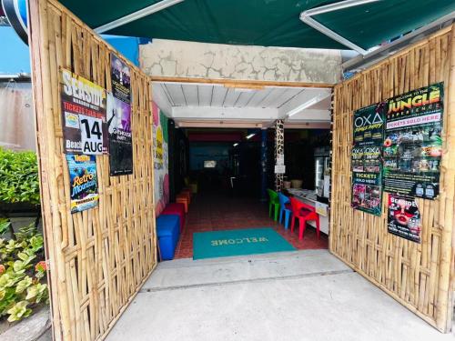 an open door to a restaurant with posters on the walls at WET Pool Party Haad Rin in Haad Rin