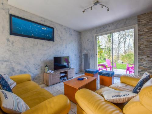 a living room with two couches and a tv at Coastal Retreat in Plurien in Plurien