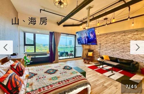 a bedroom with a bed and a brick wall at 宜蘭頭城A Happy Birthday 私人溫泉 海景 蘭陽夜景大陽台無邊際泳池 in Toucheng