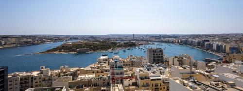 an aerial view of a city and a river at 16th Floor with Pool & 180 Sea Views by QuickTrips in Sliema