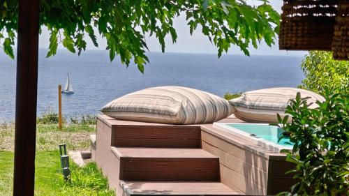 a view of the ocean from a resort with two pillows at Andy's Place , Possidi By Halkidiki Villas in Possidi