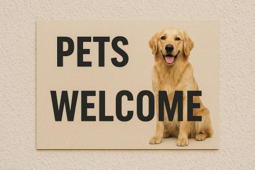 a sign that says pets welcome on a wall at Aloe Residence Possidi in Possidi
