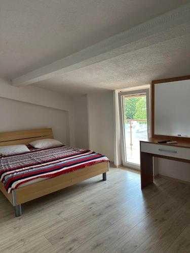 a bedroom with a bed and a flat screen tv at Villa Sparadise in Ohrid