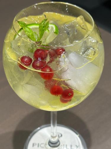 a drink with cherries and ice in a glass at Piccadilly House in Arta