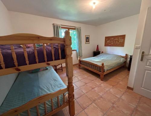 a bedroom with two bunk beds in a room at Chez Mamie in Cazes-Mondenard