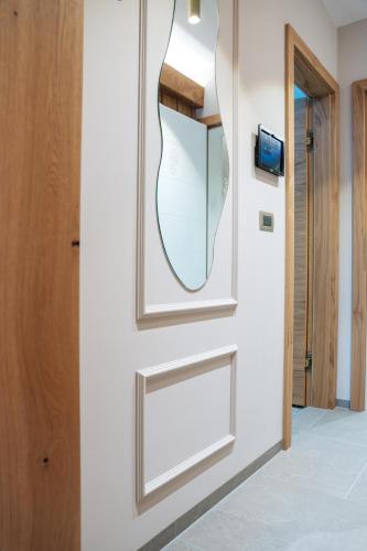 a mirror on a wall next to a door at Menart Estate in Cerklje na Gorenjskem