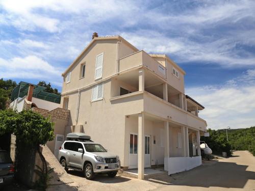a house with a car parked in front of it at Holiday Home in Korcula with Sea View in Zavalatica
