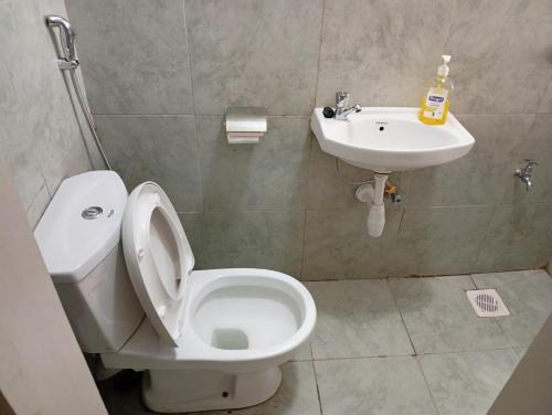 a bathroom with a toilet and a sink at ONeal Prime Suites - Furnished Studio apartments in Nairobi Near JKIA & SGR in Nairobi