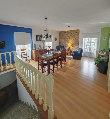 a living room and dining room with a dining table at Casa Aurora in Penacova