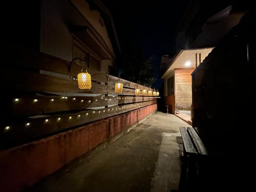 a dark alley with lights on the side of a building at Guest House TAKAO in Tanabe