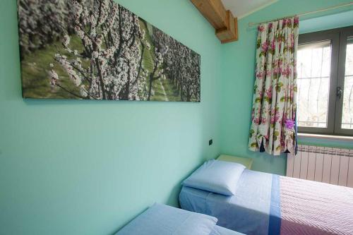 a bedroom with a bed and a painting on the wall at B&B Land & Sea in Campofilone