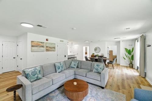 a living room with a couch and a table at Family Getaway 9BR Open-Concept Retreat home in Winston-Salem