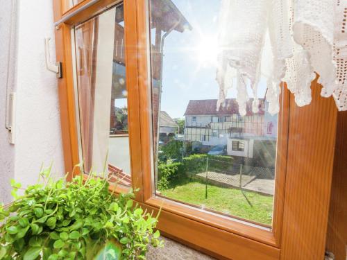 a window with a view of a house at Wohnung in Densberg nahe Kellerwald in Densberg