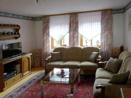a living room with a couch and a coffee table at Wohnung in Densberg nahe Kellerwald in Densberg