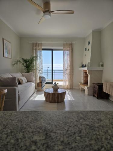 a living room with a couch and a table at Azulmaris - Direkt am Strand in Vila Chã - Terrasse und Meerblick in Vila Chã