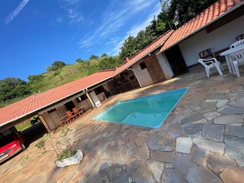 a swimming pool in a yard with a house at Rancho Monte Verde in Elói Mendes