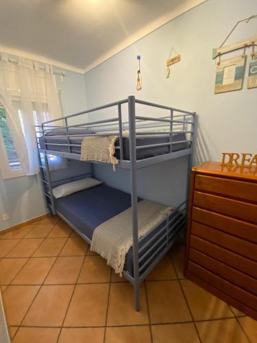 two bunk beds in a room with a dresser at Rincón de Aigua Xelida in Tamariu