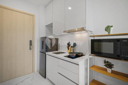 a kitchen with a sink and a microwave at Soreli by Kozystay - TB Simatupang in Jakarta