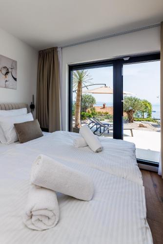a bedroom with two beds with a view of the beach at Villa Aria Prestige in Opatija