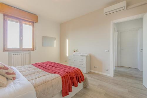 a bedroom with a bed with a red blanket on it at The Purple House between Modena and the Ferrari Museum in Modena