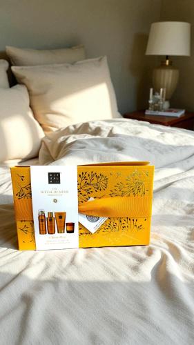 two boxes sitting on top of a bed at ROXI The Urban Residence Brussels in Brussels