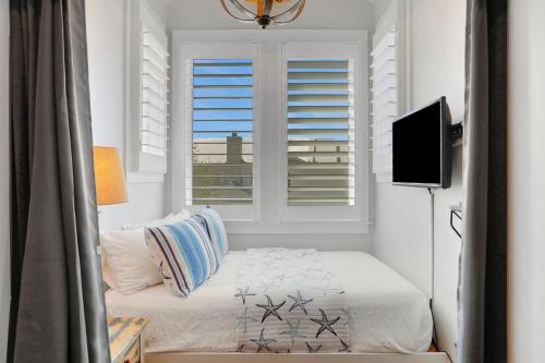 a small bedroom with a bed and a window at A Better Place in Carillon Beach