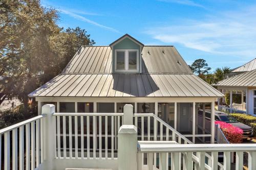 a house with a white fence at A Better Place in Carillon Beach