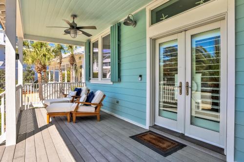 a porch with a rocking chair and a fan at A Better Place in Carillon Beach