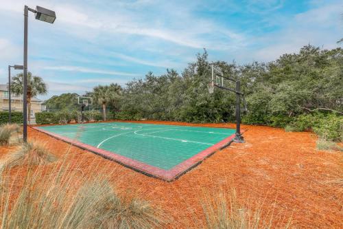 a basketball court in the middle of a field at A Better Place in Carillon Beach