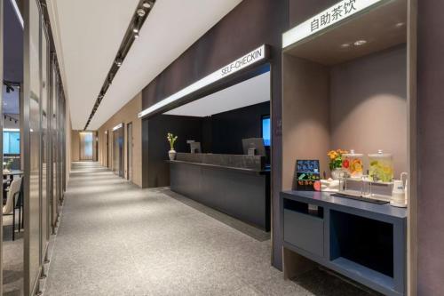 a lobby of a office building with a reception desk at Atour Light Hotel Beijing Wukesong 301 PLA Hospital in Beijing