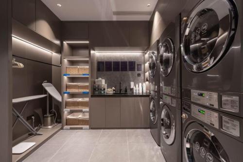 a large laundry room with two washer and dryer at Atour Light Hotel Beijing Wukesong 301 PLA Hospital in Beijing
