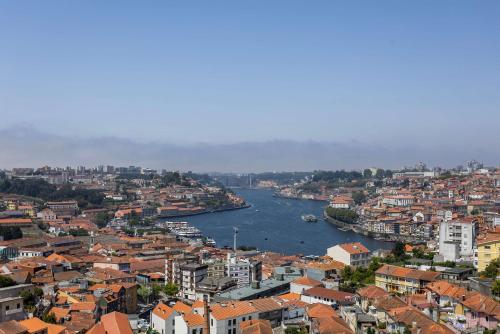 a view of a city with a river and buildings at Liiiving in Gaia - Douro Balcony View in Vila Nova de Gaia